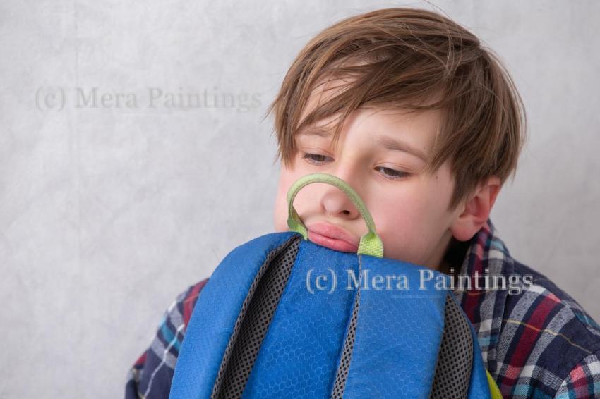 Feeling bored at home during a rainy afternoon while holding a backpack close