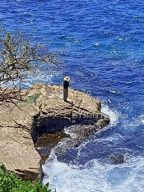 Man standing on the rock at Bondi beach