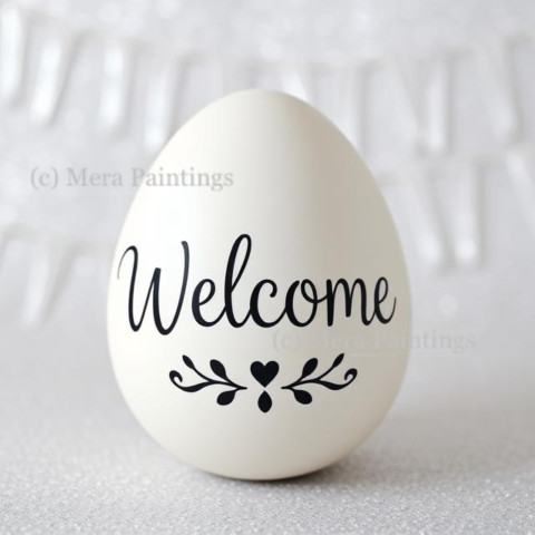 "Welcome" sign on white egg