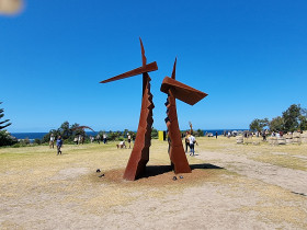 brown metal hammer type sculpture